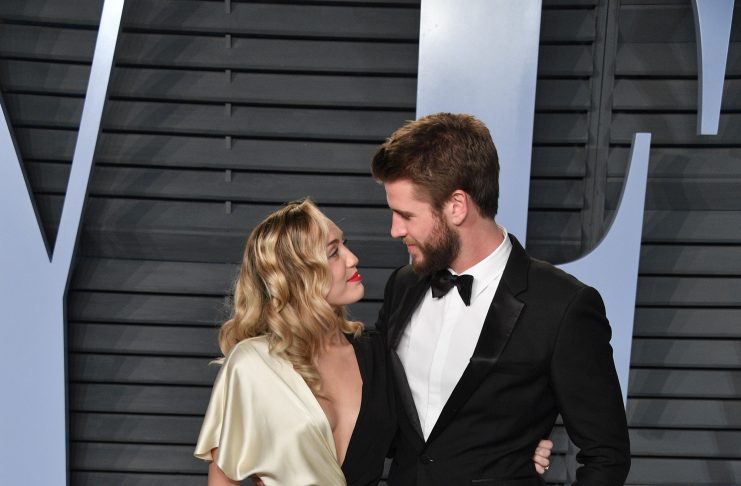 Liam Hemsworth in Burberry and Miley Cyrus in Prabal Gurung