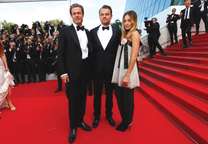 Brad Pitt in Brioni, Leonardo DiCaprio in Giorgio Armani, Margot Robbie in Chanel at the premiere of Once Upon a Time in Hollywood